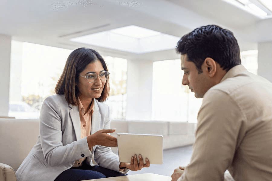 Bank officer assisting a customer with a tablet