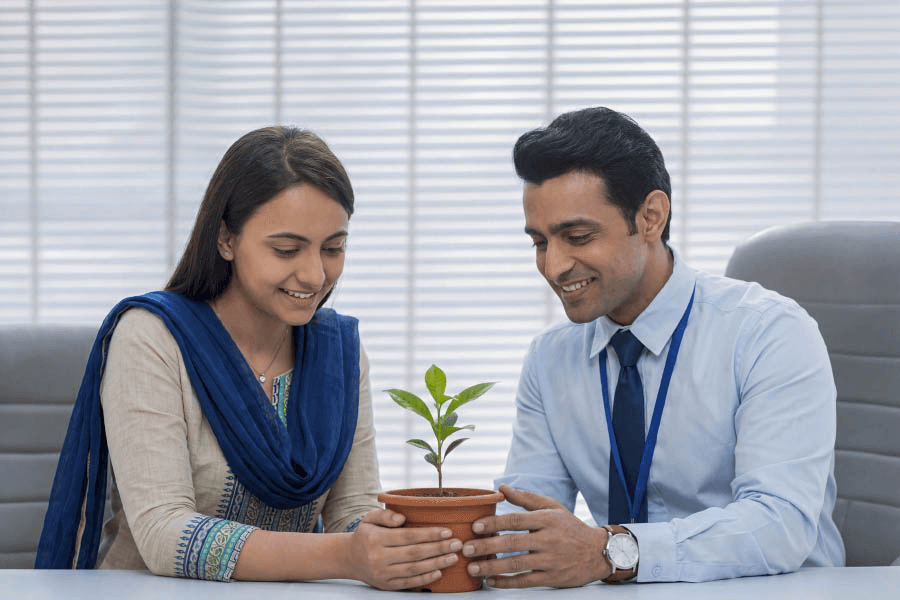 Couple tending a potted plant